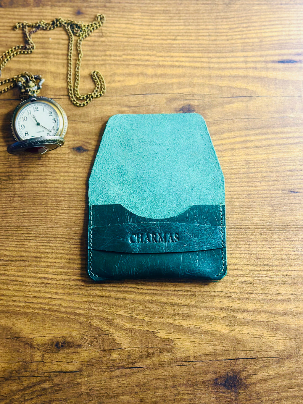 Compact dark forest green leather wallet lifestyle shot