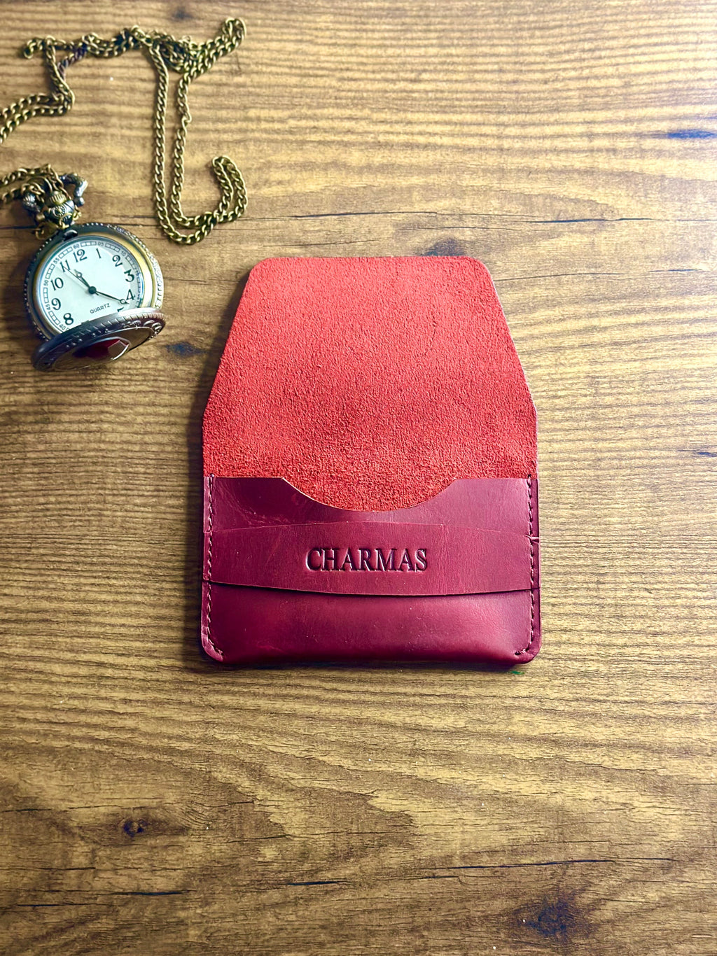 Cherry red compact wallet showing card slot and slim profile
