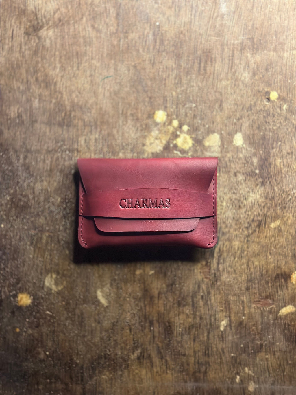 Compact cherry red leather wallet lifestyle image