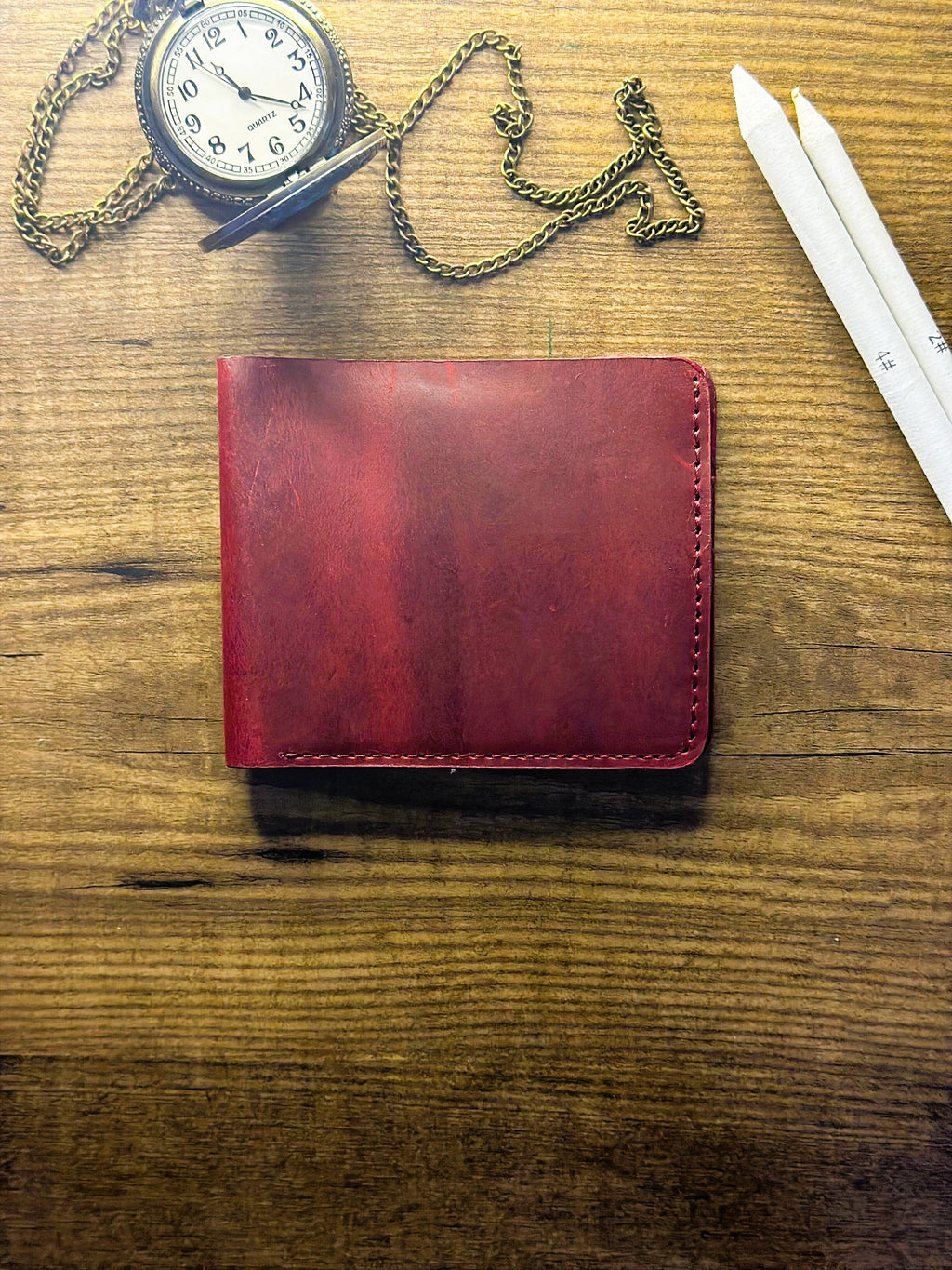 Cherry maroon bi-fold wallet front view in oil pull-up leather