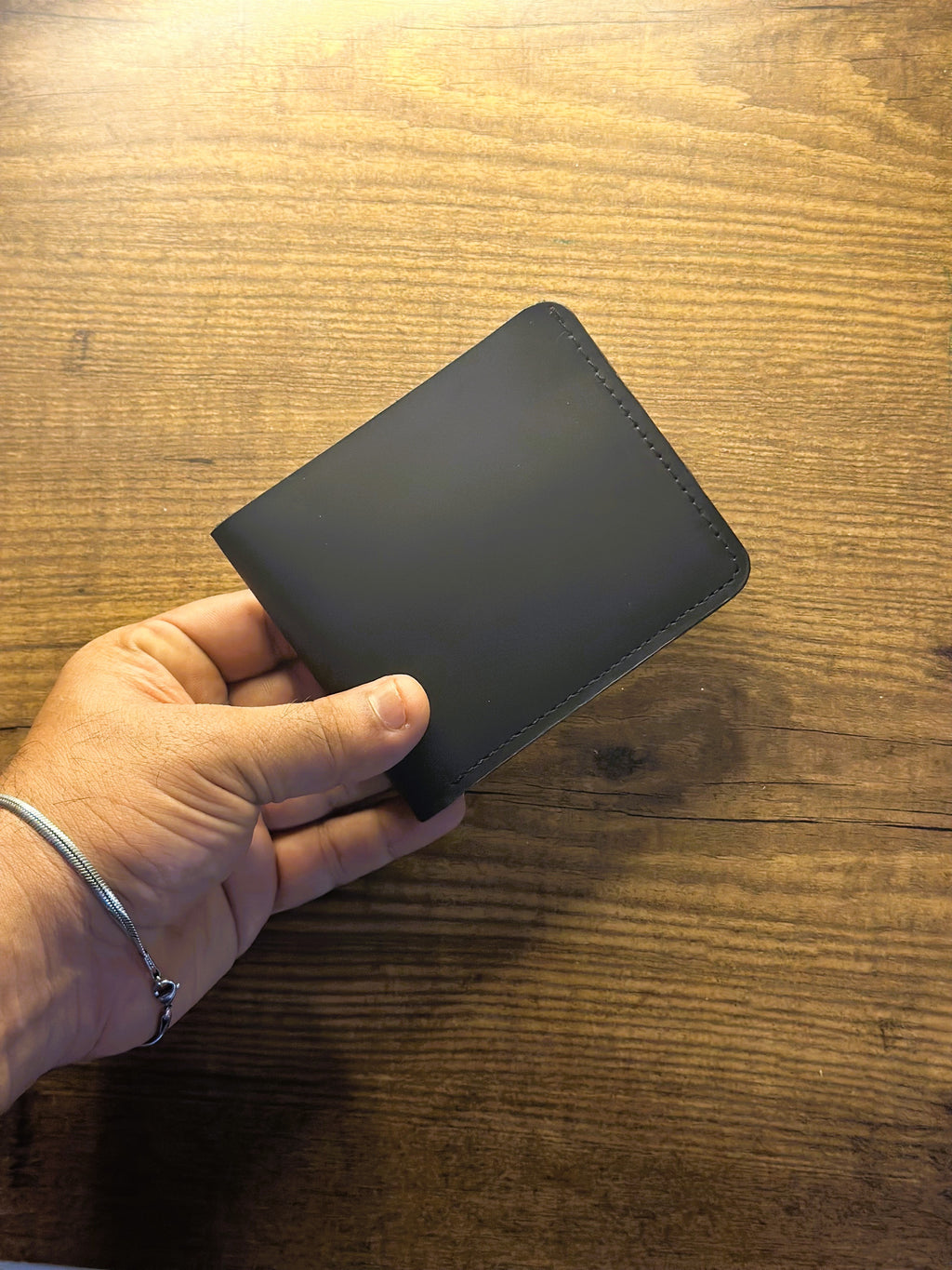 CHARMAS black leather bi-fold wallet product shot