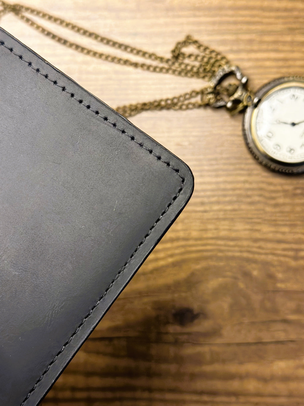 Premium leather texture close-up of CHARMAS black wallet"