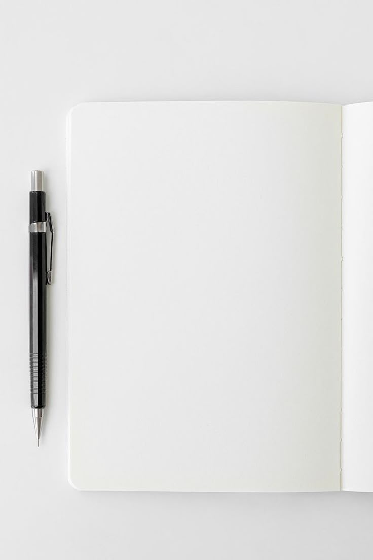 Open notebook with a pen on a white background
