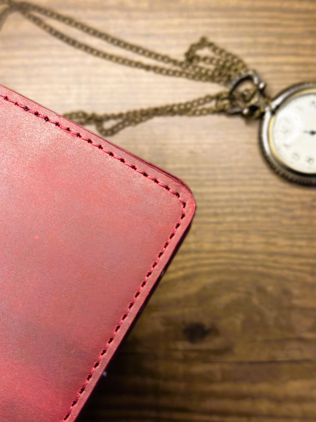 Cherry maroon wallet close-up showing refined stitching detail